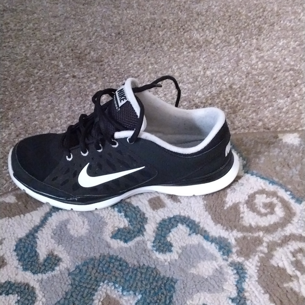 Used black and white Nike training shoes.